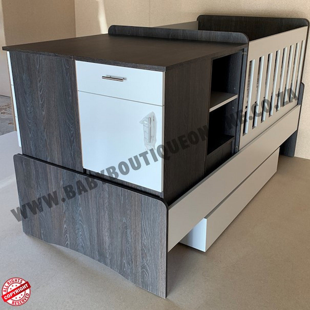 Children's BabyBedrominabox5-in-1Cot with wooden finish and white drawers, branded 'Bab Boutique'.