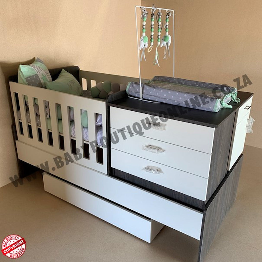 BabyBedrominabox5-in-1Cot Baby crib with changing table and decorative items on a beige background