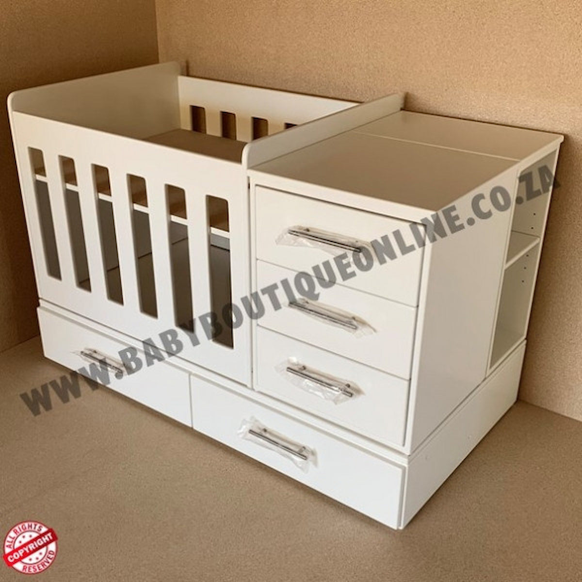 BabyBedroominaBox4-in-1 White baby crib with drawers against a beige wall