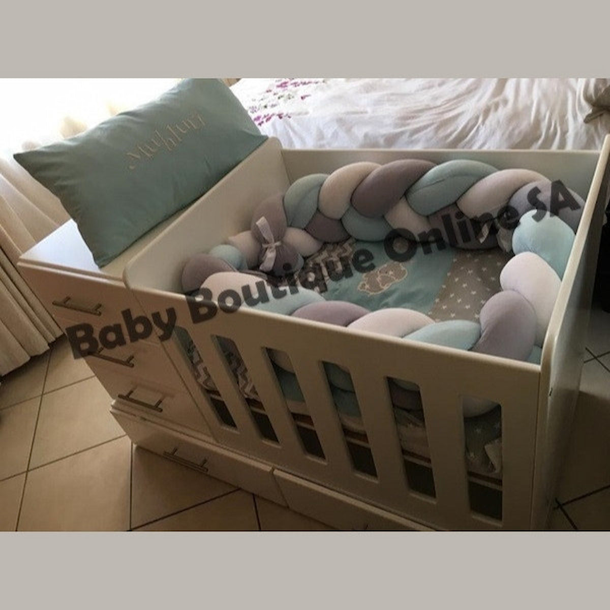 BabyBedroominaBox4-in-1 Baby crib with colorful braided bumper and 'Baby Boutique Online' branding.
