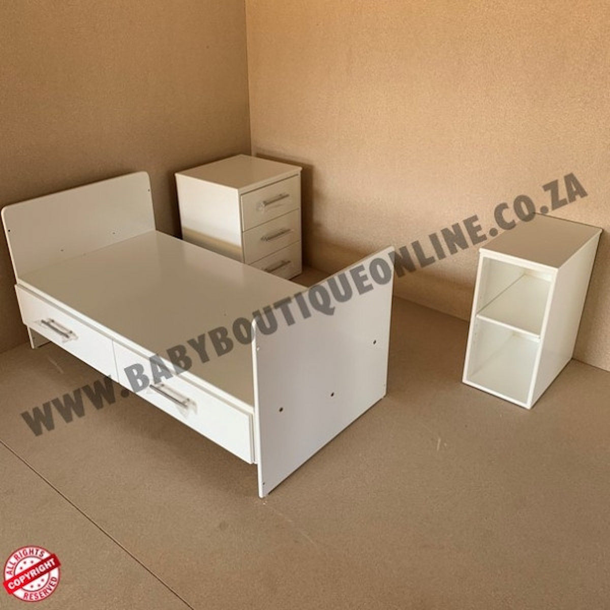 White children's bed with two side tables on a brown floor, with 'BabyBoutiqueOnline.co.za' branding.