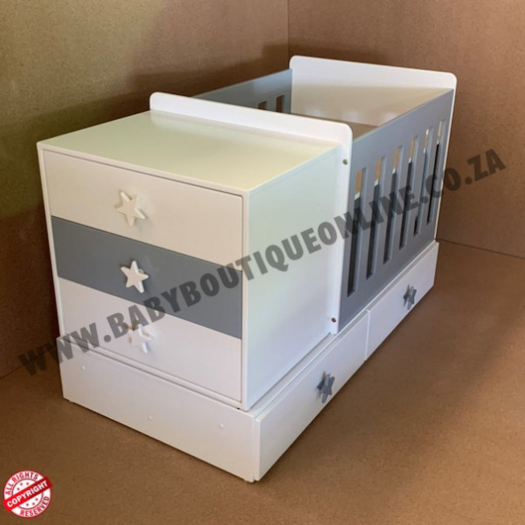 BabyBedroominabox4-in-1ToddlerCot white and gray crib with star designs on a brown background