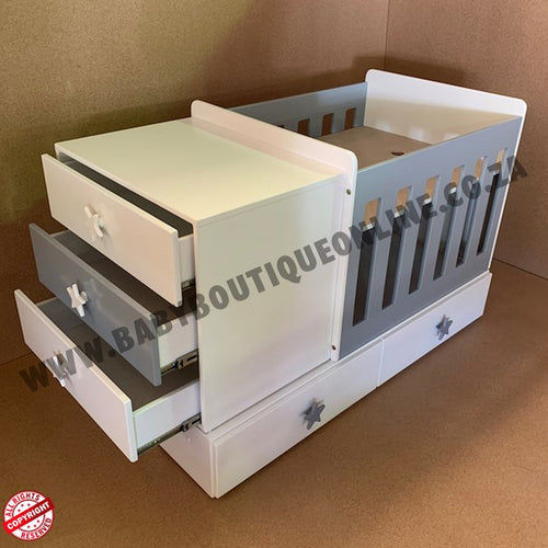 BabyBedroominabox4-in-1ToddlerCot  with multiple drawers on a brown background