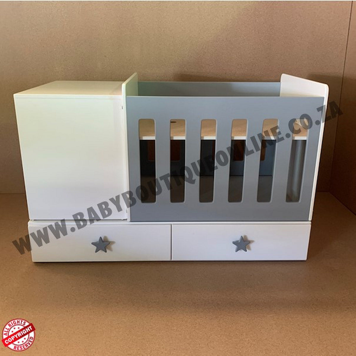 BabyBedroominabox4-in-1ToddlerCot White baby crib with star designs on a brown background