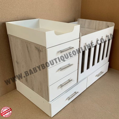 4-in-1-ChestofDrawers White and wood changing table with drawers on a brown background