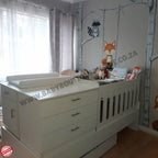 Bedroominabox-5-in-1Cot White baby crib with changing table in a nursery with wall art and curtains.