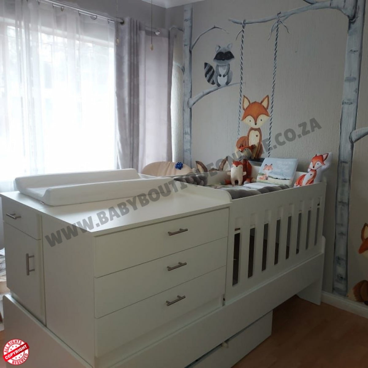 Bedroominabox-5-in-1Cot White baby crib with changing table in a nursery with wall art and curtains.