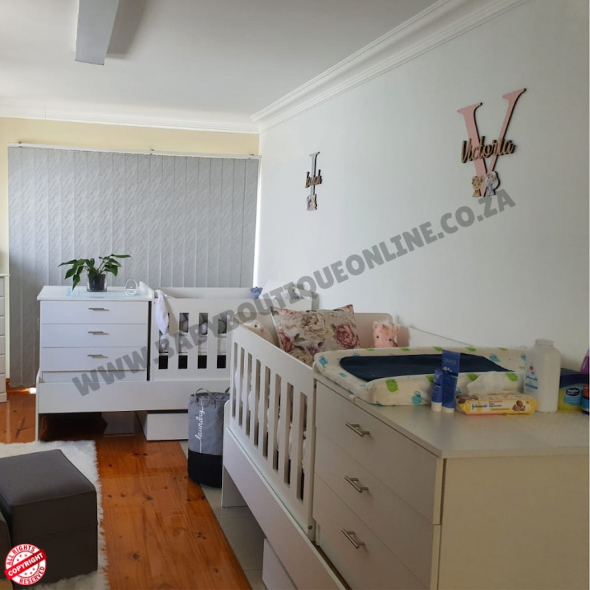 Children's bedroom with Bedroominabox-5-in-1Cot white crib, dresser, and toys on a wooden floor.