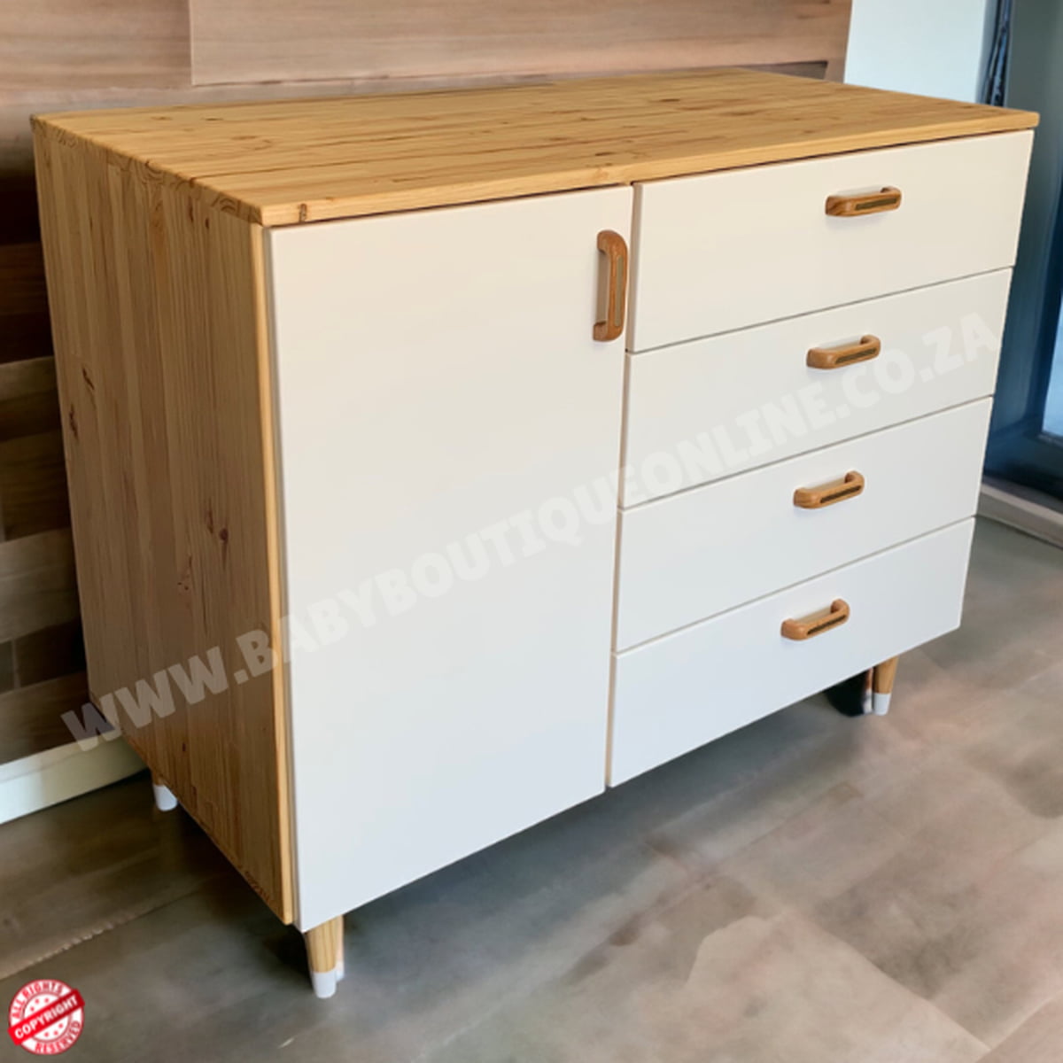 Wooden cabinet with white doors and drawers in a room setting