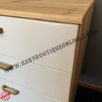 White dresser with wooden top and handles, featuring a website URL.
