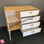 Wooden furniture with drawers and a shelf on a gray floor.