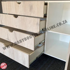 Wooden drawers being pulled out from a cabinet with visible branding.