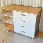 Wooden cabinet with white drawers and wooden top on a light wooden floor.