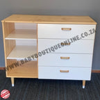Wooden desk with white drawers against a gray wall