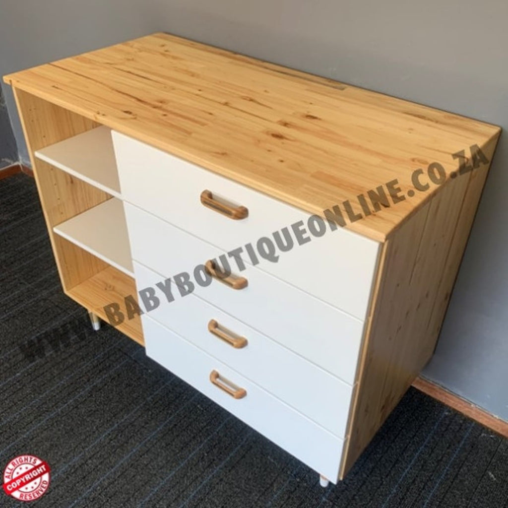 Wooden cabinet with white drawers and gold handles on a gray floor.