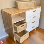 Wooden cabinet with wicker baskets on a wooden floor