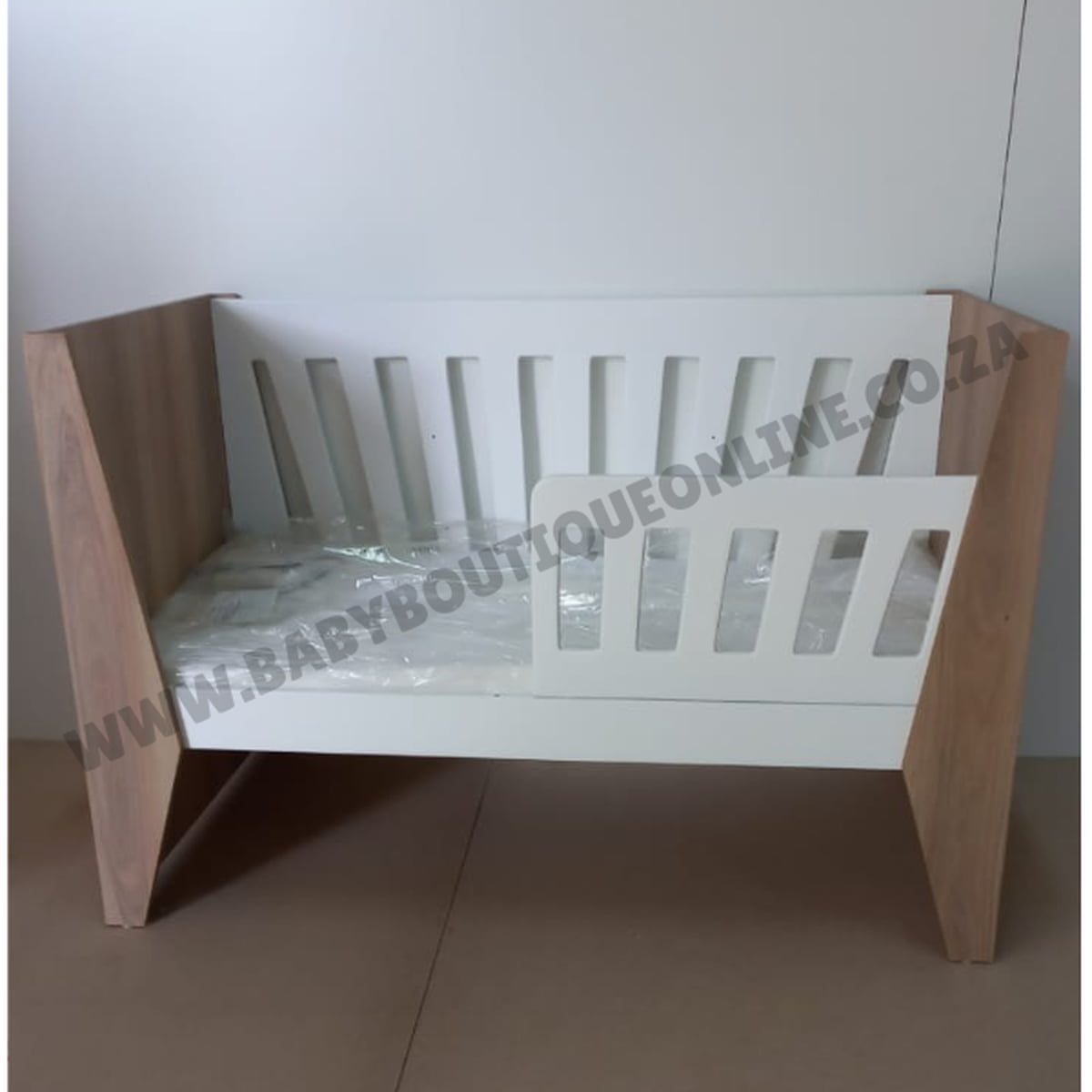 Emma Large Wooden Cot-White_Sahara Wooden crib with white mattress on a plain background