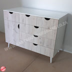 Wooden dresser with white top on a plain floor, brand 'Rabrou' visible.
