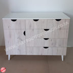 Wooden dresser with white top and black handles on a plain background