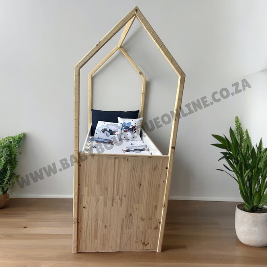 Tent Large Cot-White_OakSmoke-shaped shelf with decorative items against a white wall.