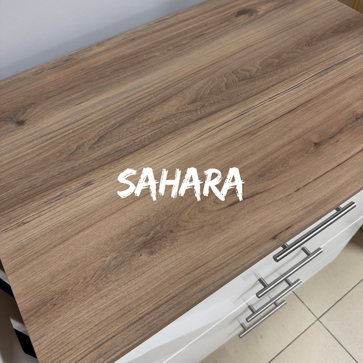 BabyBedroominaBox-5-in-1Cot Wooden surface with 'SAHARA' branding on a kitchen counter. 