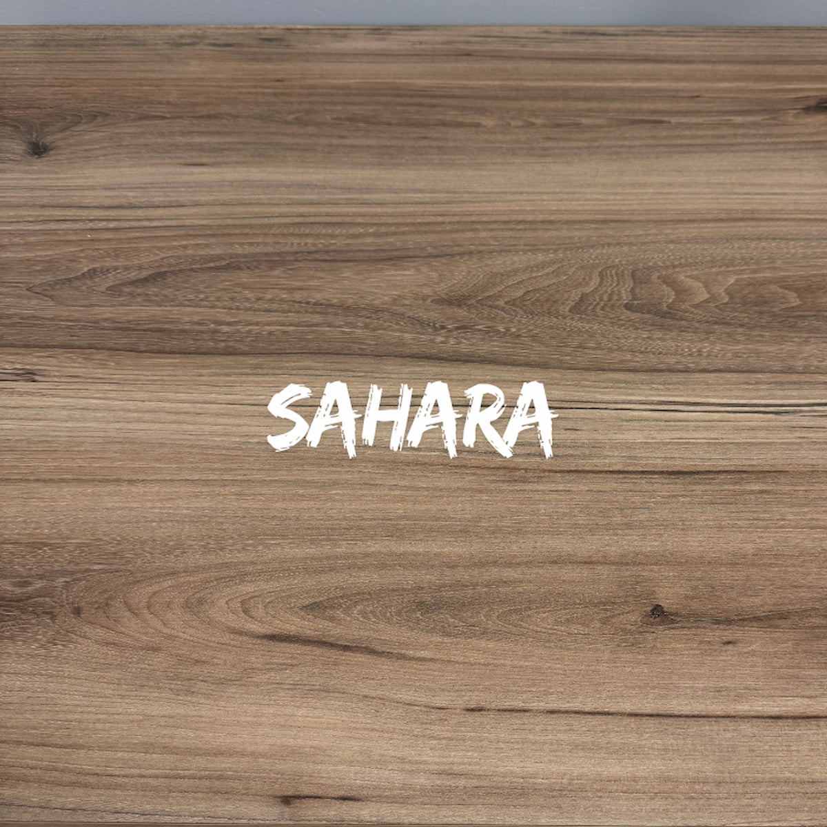 Wooden surface with 'SAHARA' text in white