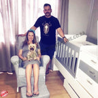 Rickus Nel and his wife with a dog in a room with a BabyBedroominaBox5-in-1Cot crib