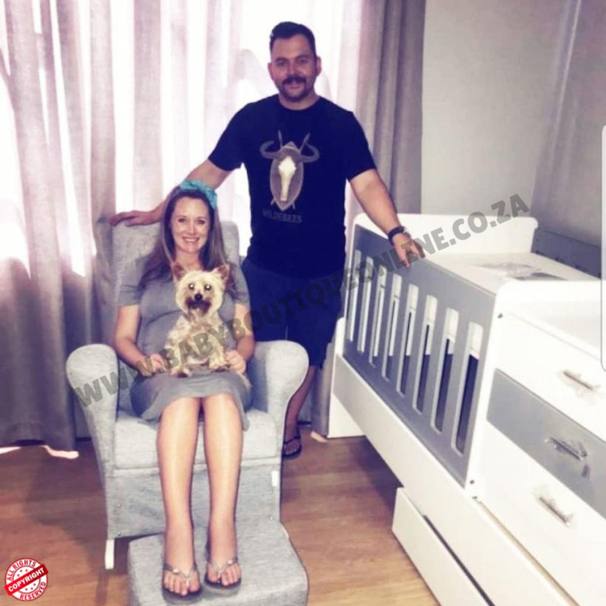 Rickus Nel and his wife with a dog in a room with a BabyBedroominaBox5-in-1Cot crib