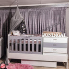 BabyBedroominaBox5-in-1Cot Nursery room with crib, changing table, and decorative elements.
