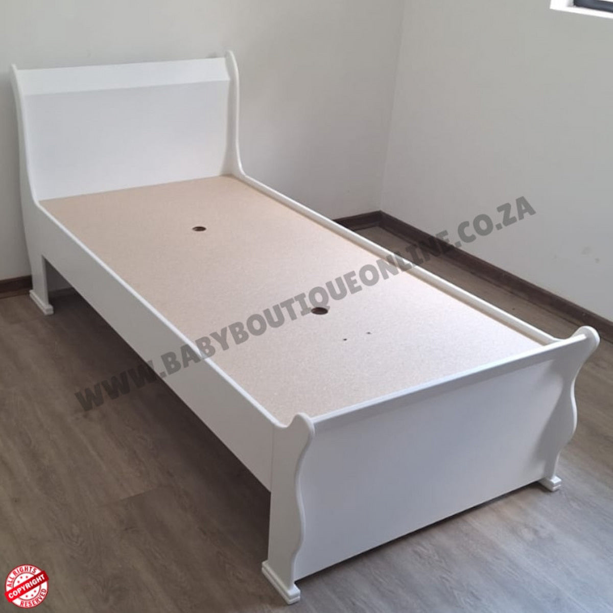 BabyBedroominabox5-in-1SleighCot White bed frame on a wooden floor with a visible brand logo.