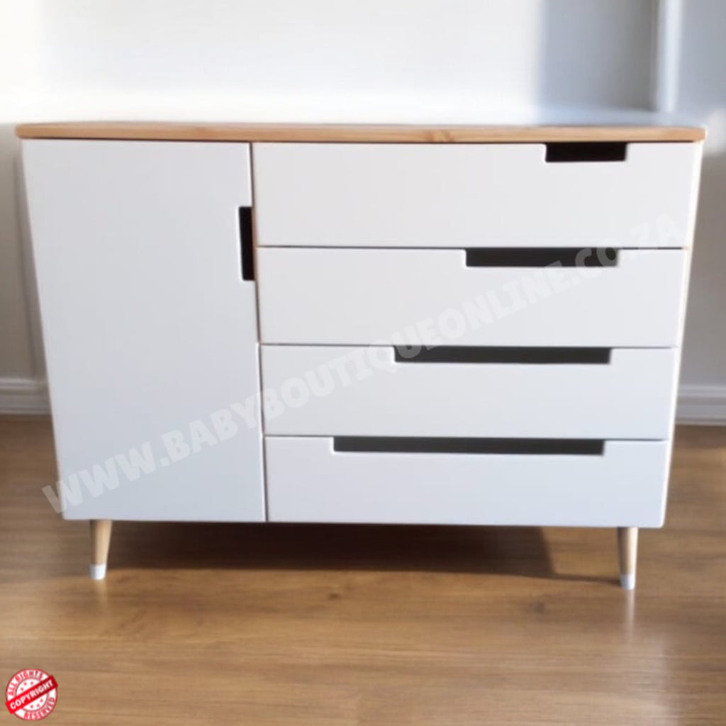 White dresser with wooden top on a wooden floor