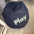 Navy bean bag chair with 'Play' text on a wooden floor.