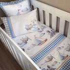 Baby crib with airplane and sailboat patterned bedding