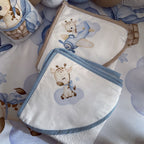 Baby blanket with giraffe design on a patterned surface