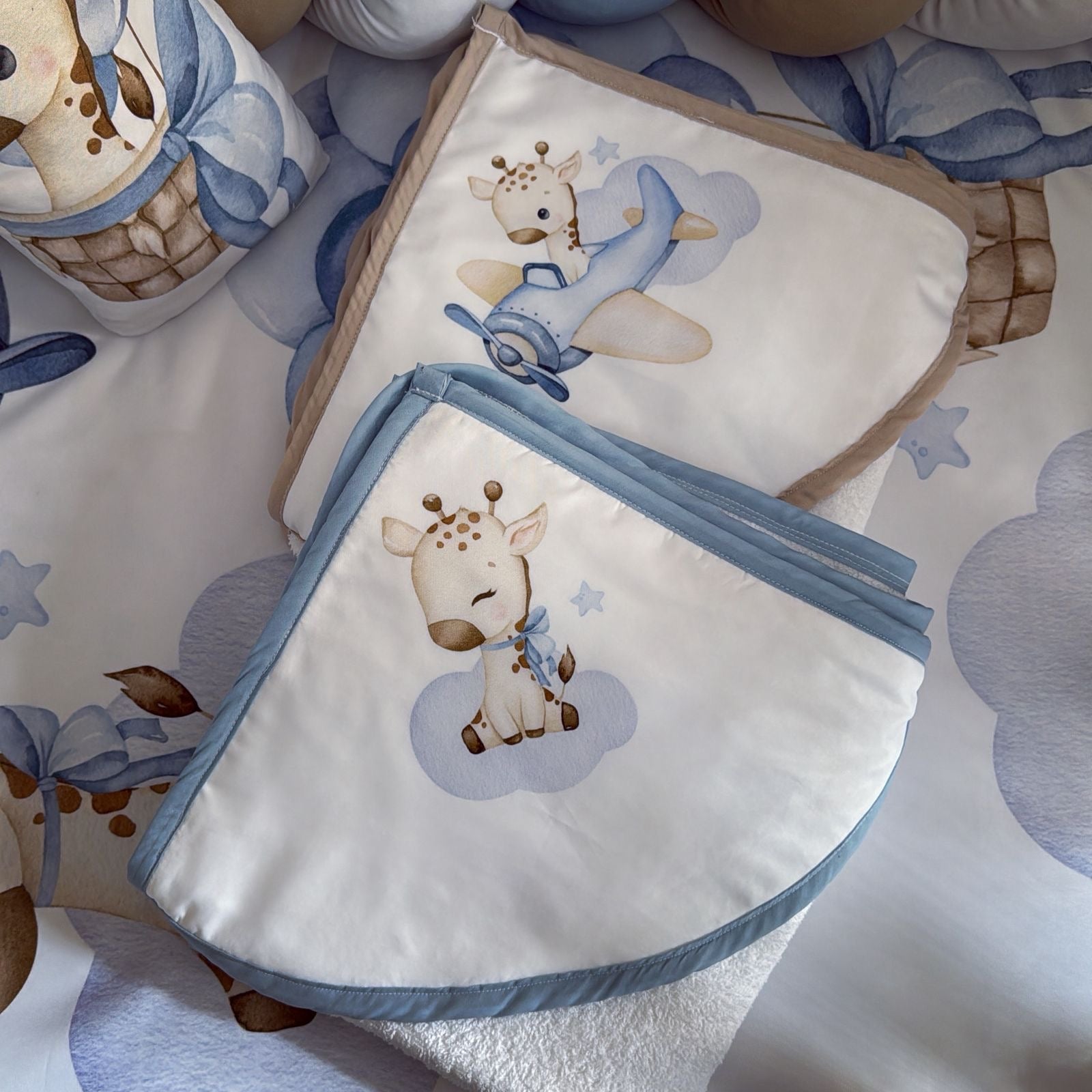 Baby blanket with giraffe design on a patterned surface