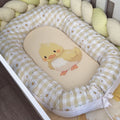 Baby nest with a cartoon duck design on a wooden floor