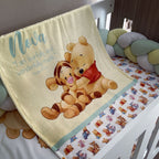 Baby crib with Winnie the Pooh and Tigger blanket and bedding.