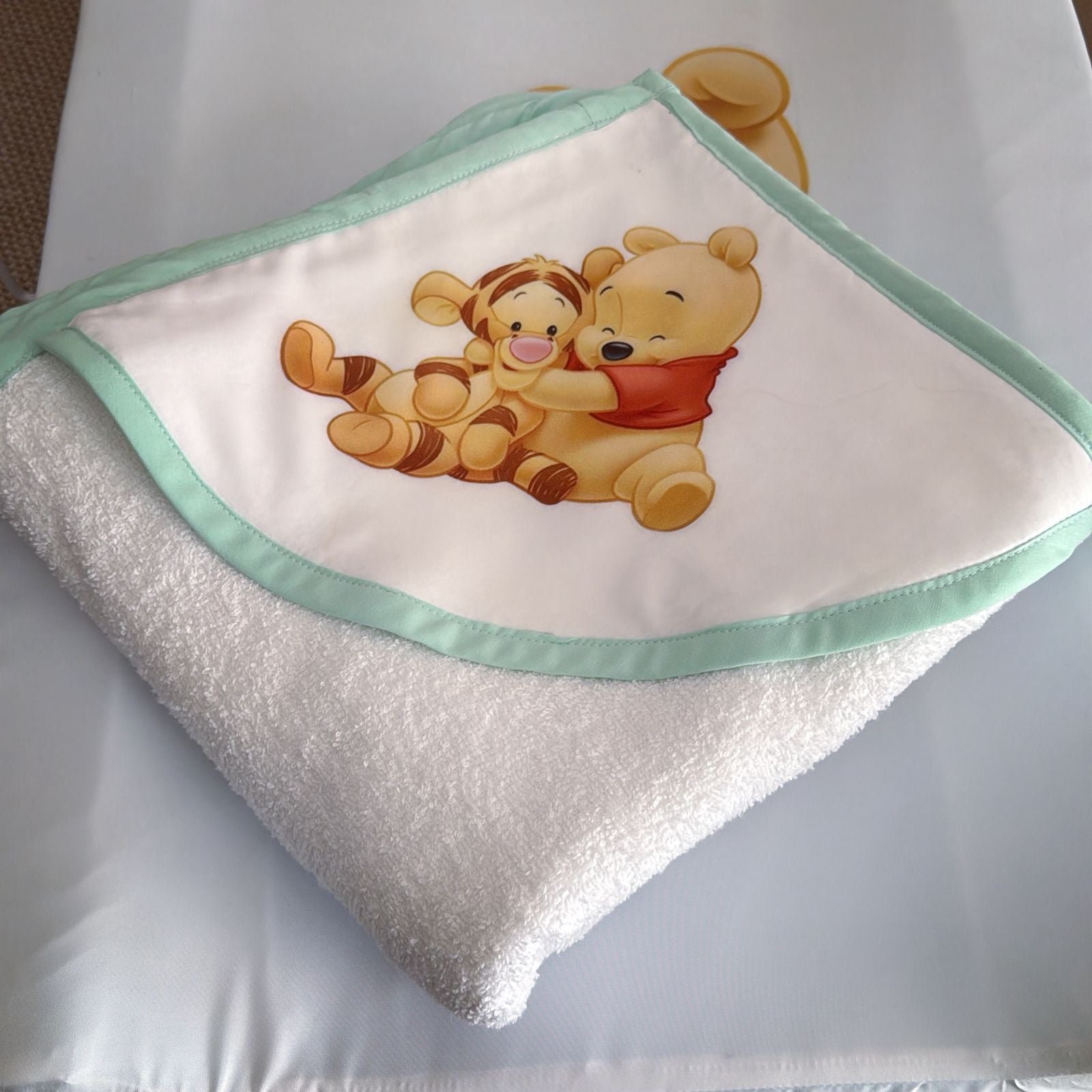 Baby blanket with cartoon characters on a white surface