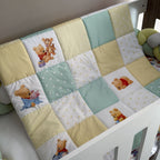 Patchwork quilt with cartoon bear designs on a crib