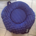 Blue cushion with white star pattern on a tiled floor