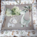 Baby crib bumper with dinosaur illustrations on a patterned background