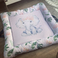A soft play doughnut with an illustration of an elephant in the center, surrounded by green leaves and a pink floral border.
