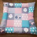 Children's play mat with patterns and toys on a wooden floor