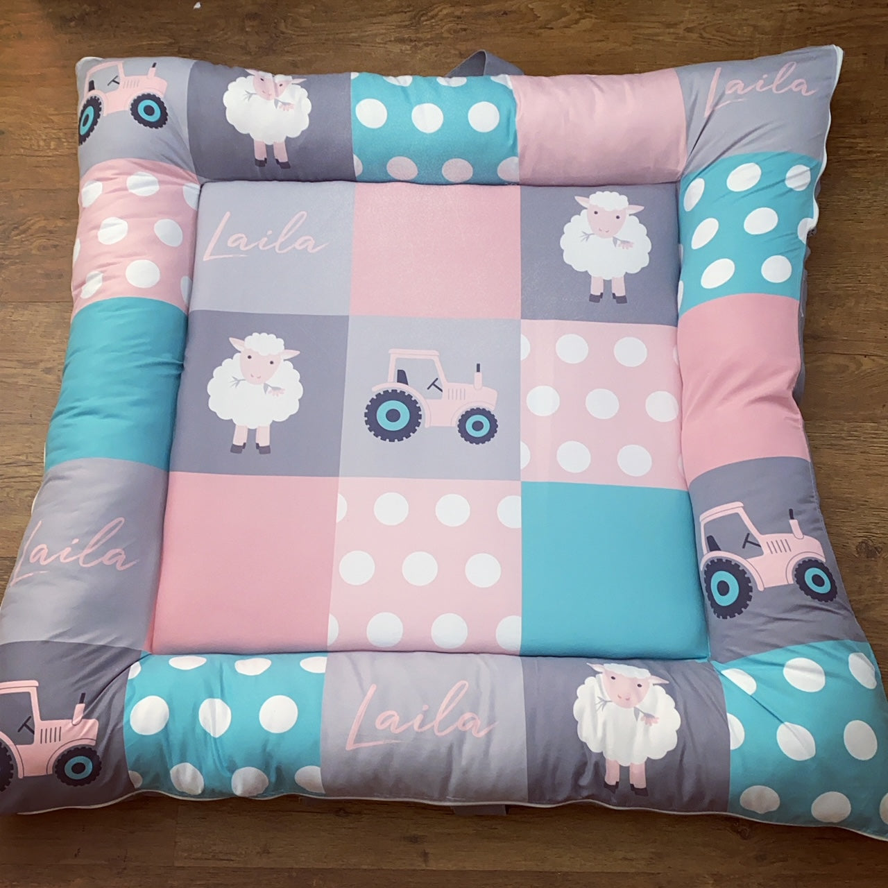 Children's play mat with patterns and toys on a wooden floor