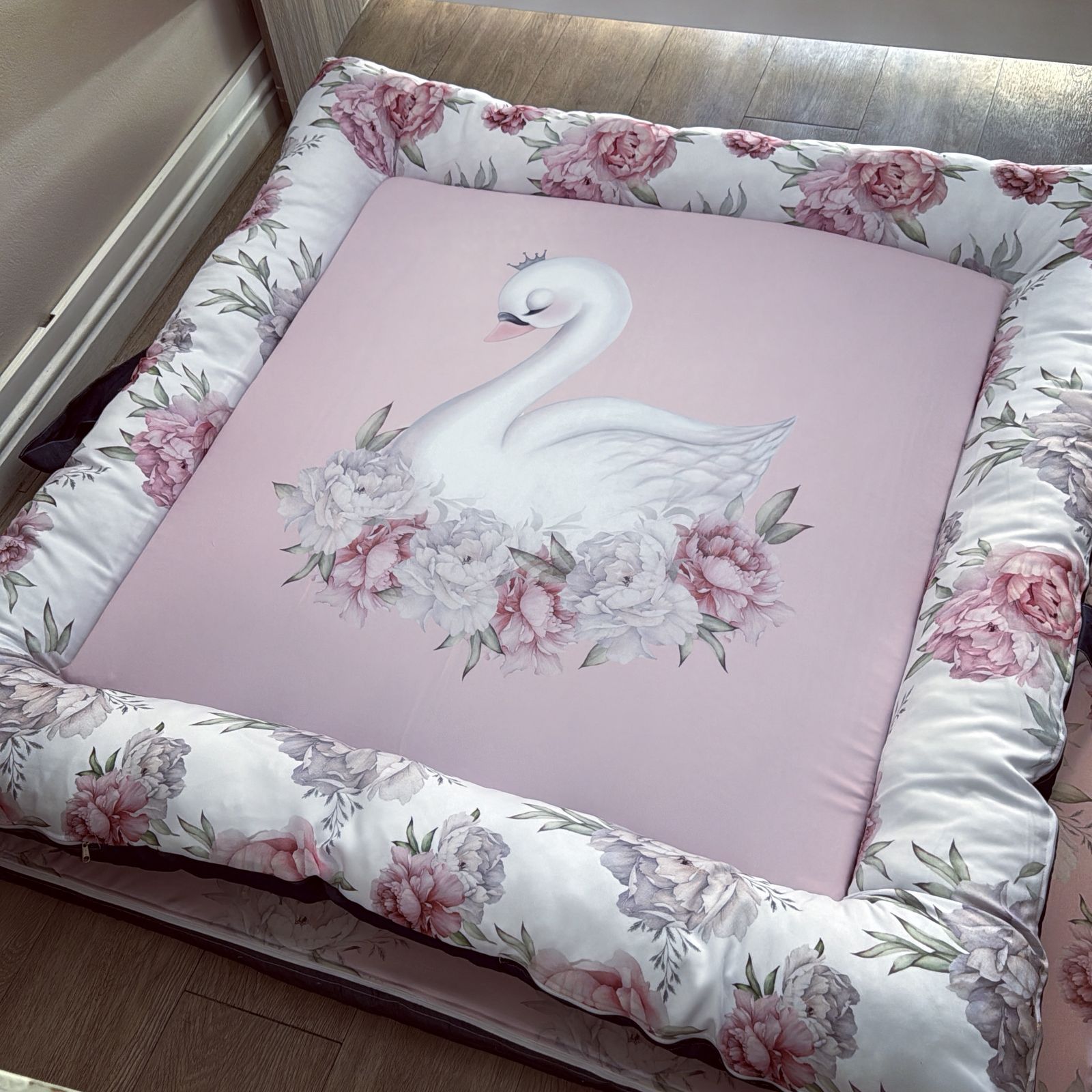 Doughnut - Pink Swan 01 Floral cushion with a swan design on a bed
