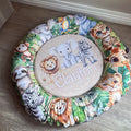 Doughnut - Stone Safari 01 with animal prints and 'Clayton' embroidery on a wooden floor.
