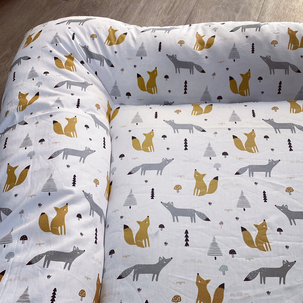 Baby Doughnut - Woodlands 01with fox pattern on a wooden floor