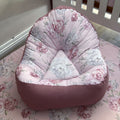 Floral-patterned bean bag chair on a floral bedspread