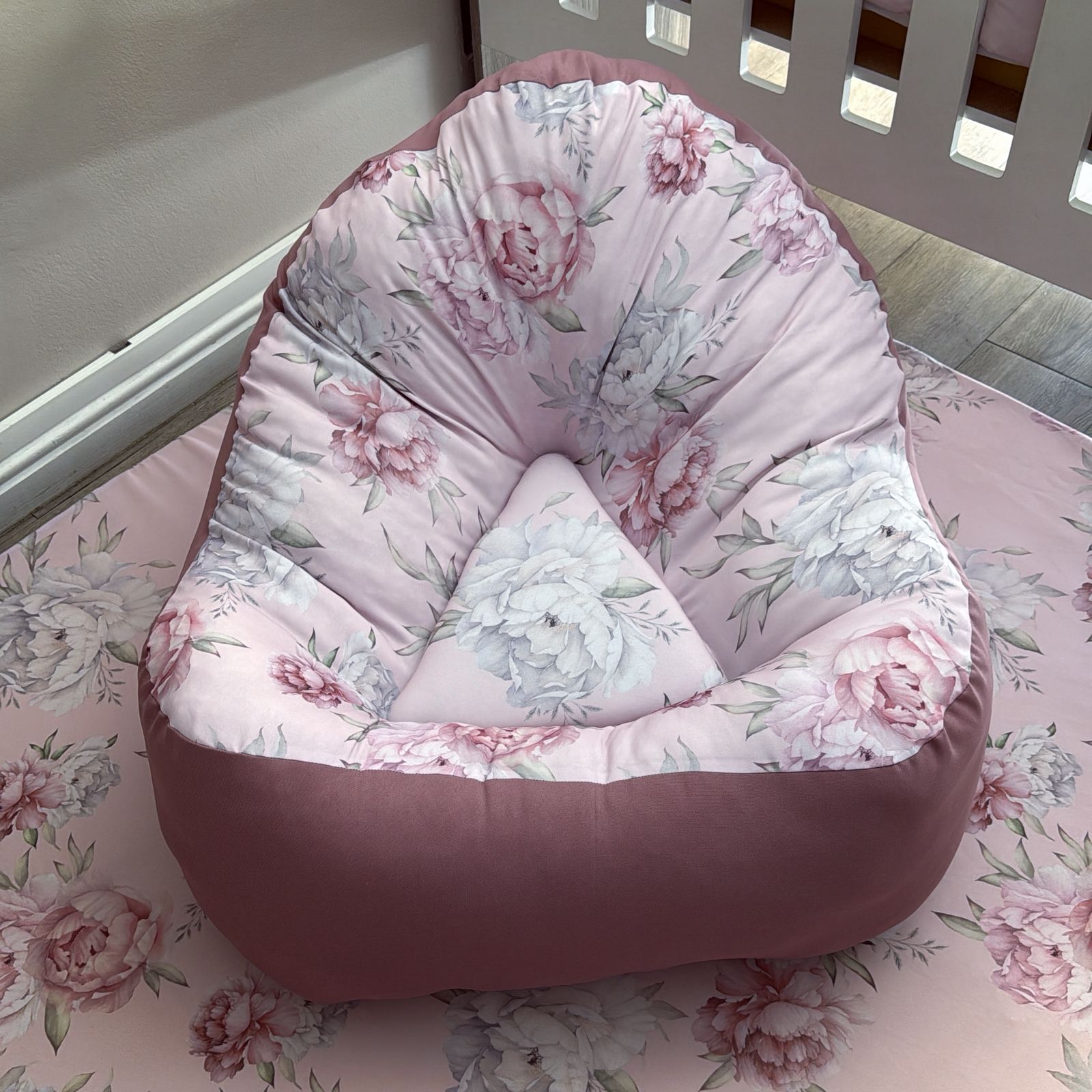 Floral-patterned bean bag chair on a floral bedspread