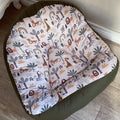 A bean bag chair with a safari animal print, primarily in shades of green and beige, with a soft, upholstered top and a sturdy, dark green base.